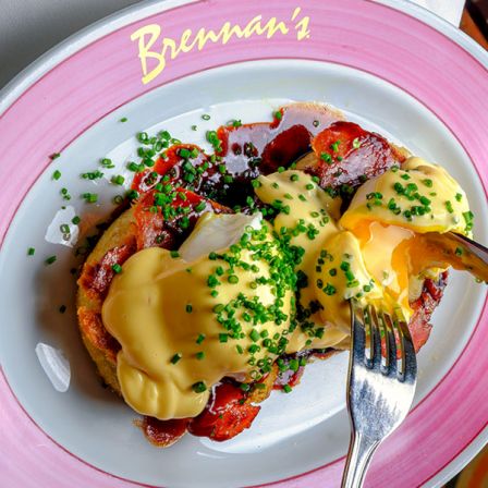 A plate of Bremerman&rsquo;s eggs Benedict with poached eggs, hollandaise, and chives on toast.